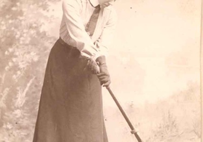Constance Applebee holding a field hockey stick