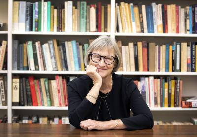 Drew Gilpin Faust with a bookshelf in the background