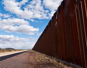 Fence at the border against a blue sky