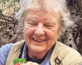 Kate Wallace holding a tody, a native Caribbean bird.