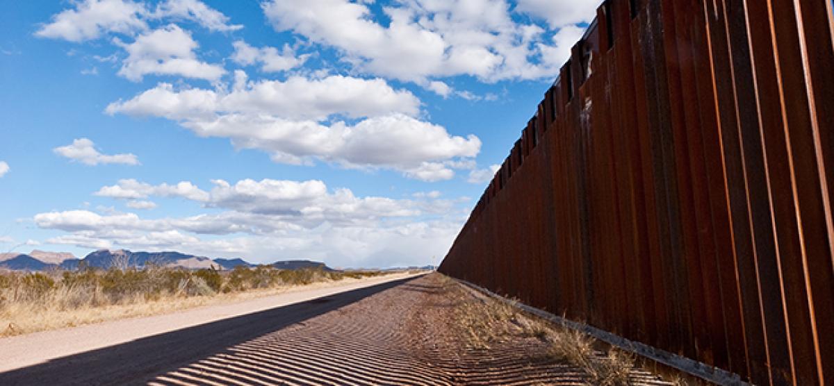 Fence at the border against a blue sky