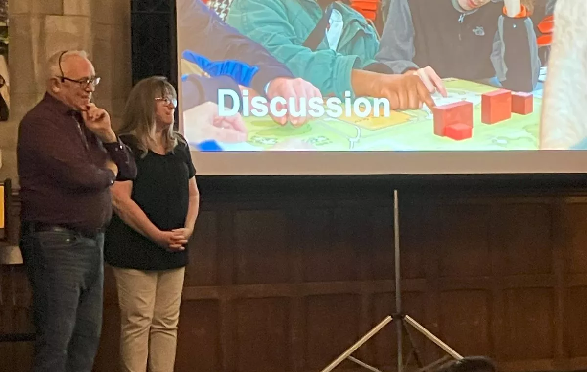 Melanie Drolsbaugh and Hansel Bauman answer questions on stage during the DeafSpace keynote event