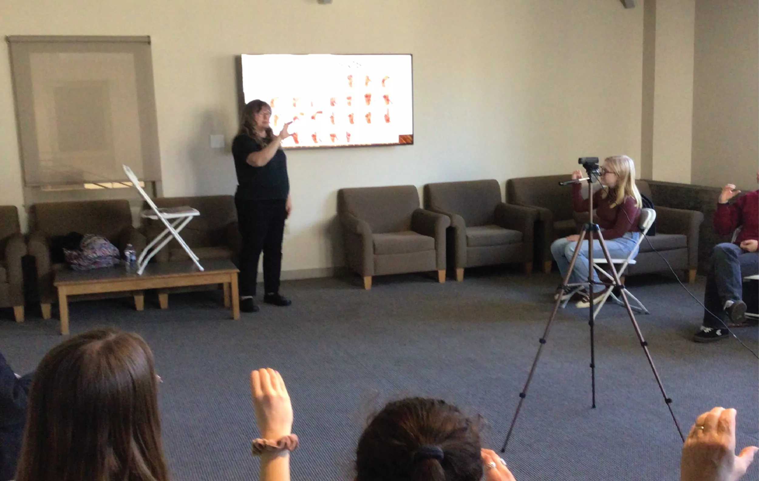Melanie Drolsbaugh teaches participants how to fingerspell during the ASL Workshop.