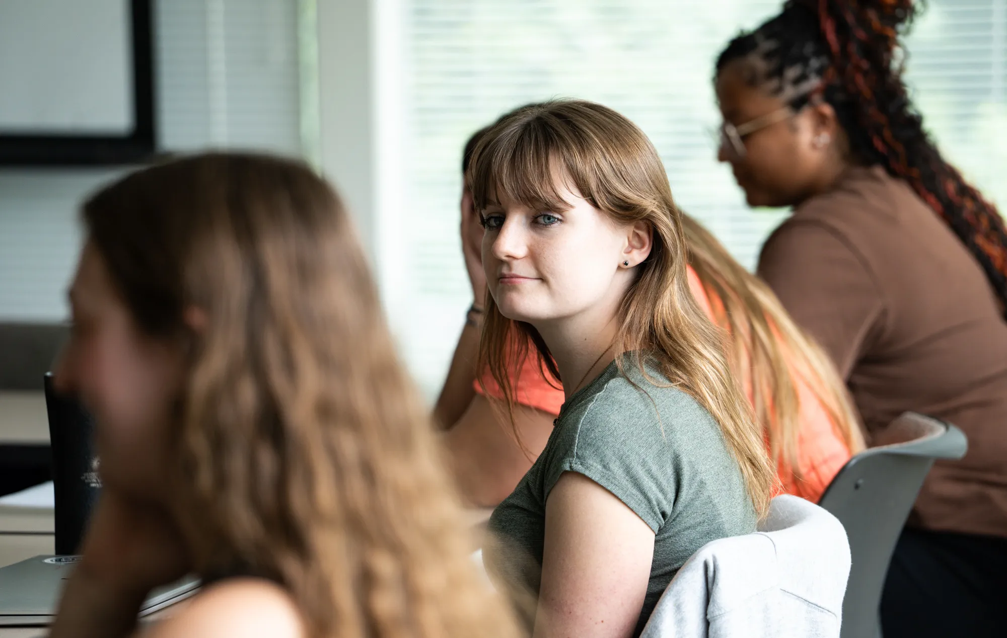 student looking at student, listening