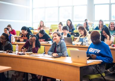 students in classroom taking notes