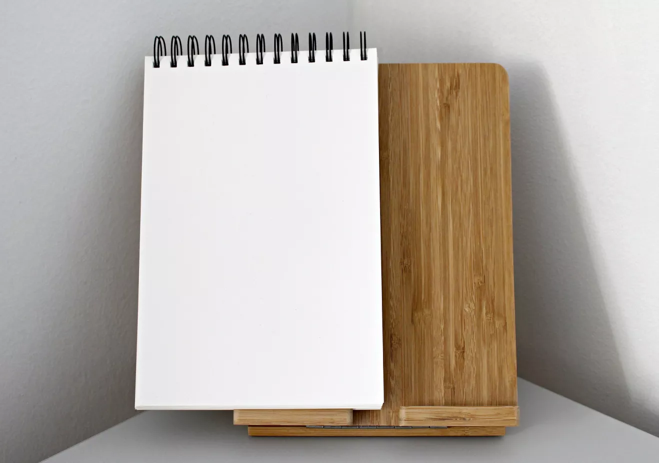 Open notebook standing on a wooden stand