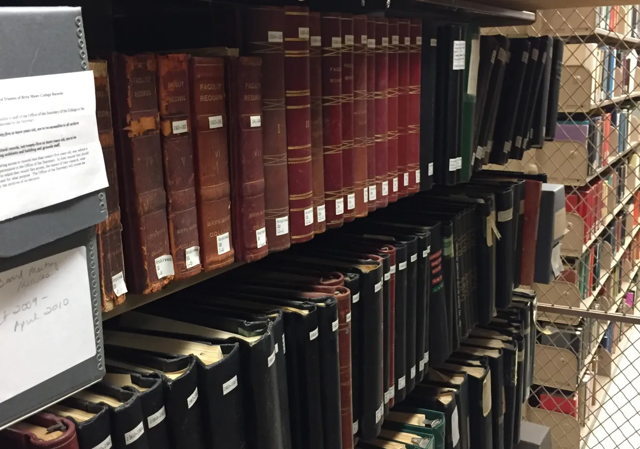 Image of hollinger boxes and bound volumes on shelf.