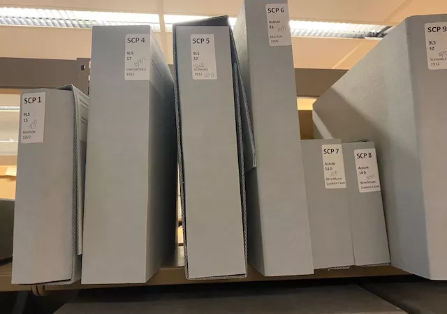 Photograph of scrapbooks in archival boxes.