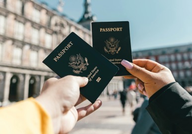 Two people holding passports