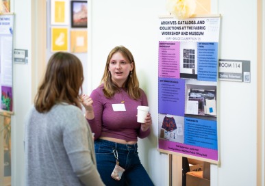 Student presenting during the Praxis Poster Session event