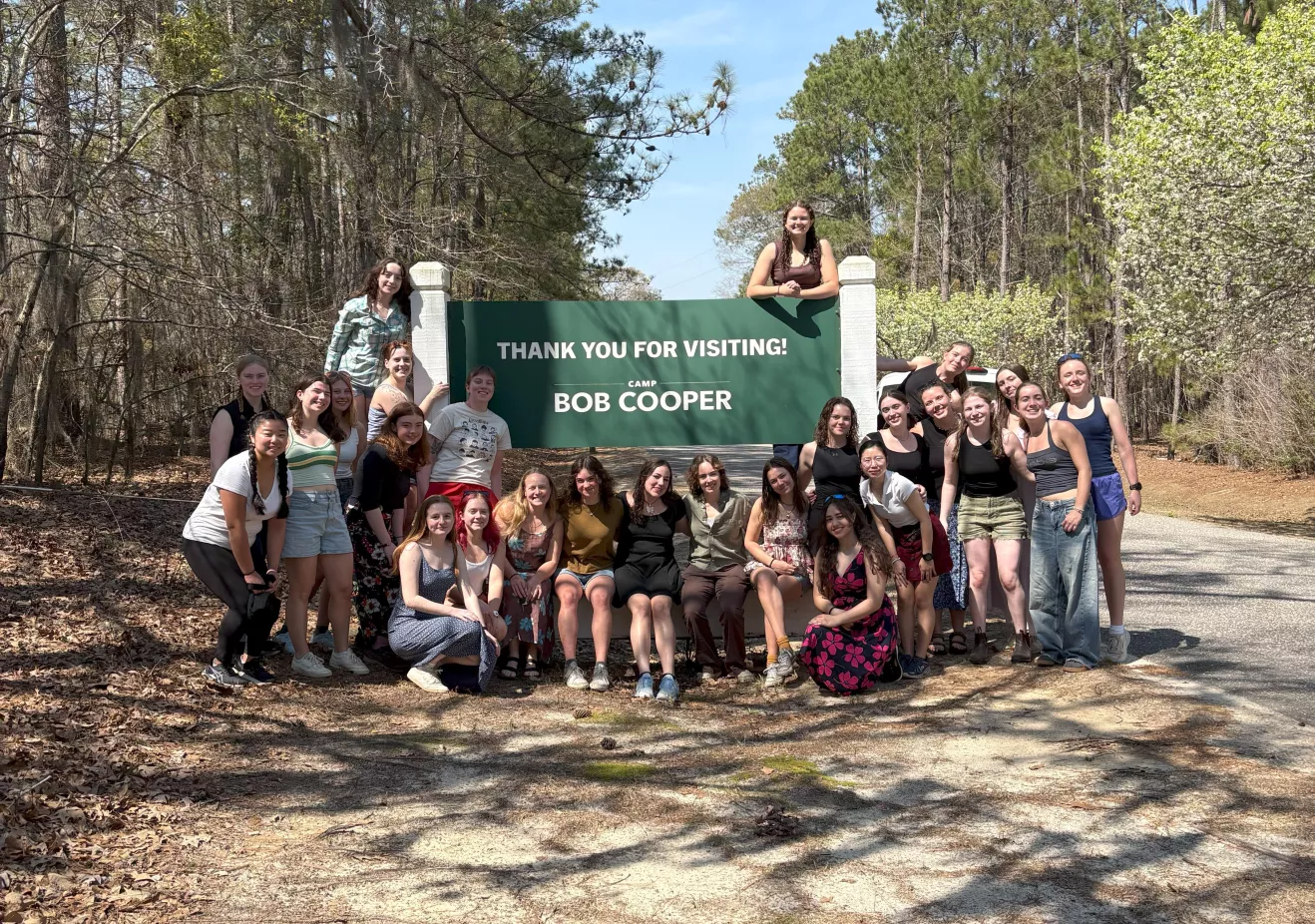 students gathered around a sign