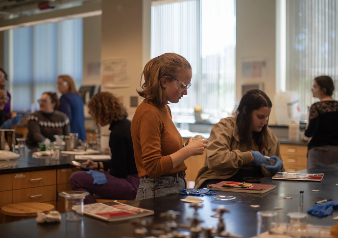 An archeology degree student doing lab research with her phd in archaeology faculty