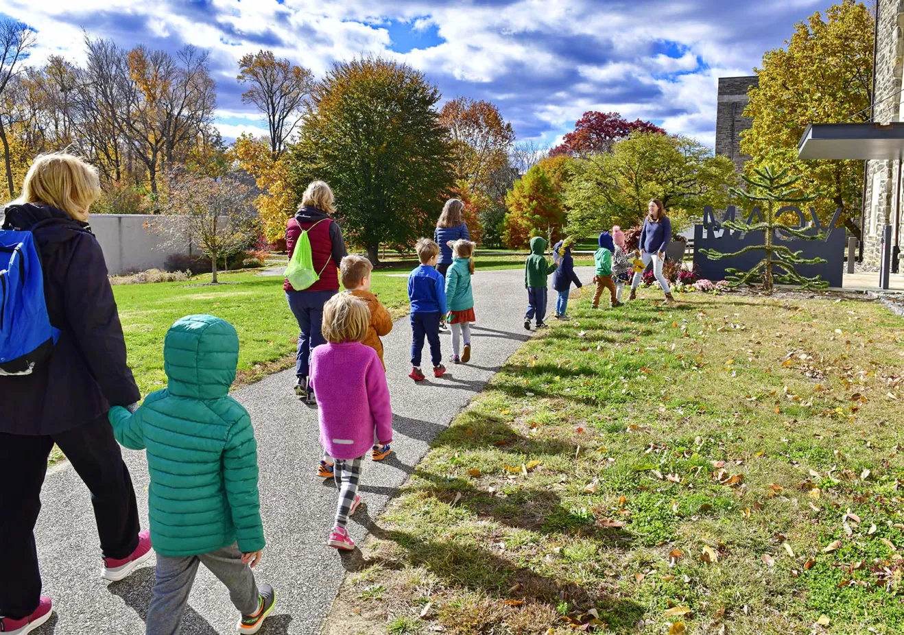 Students and teachers walking along a path