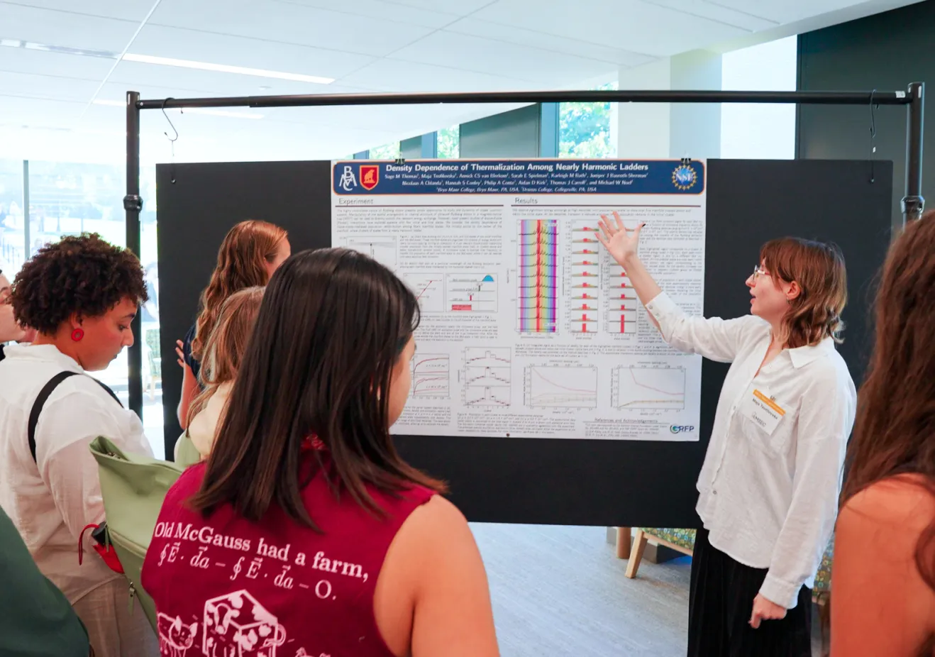 A student with presents quantum physics findings to a group of undergraduate researchers