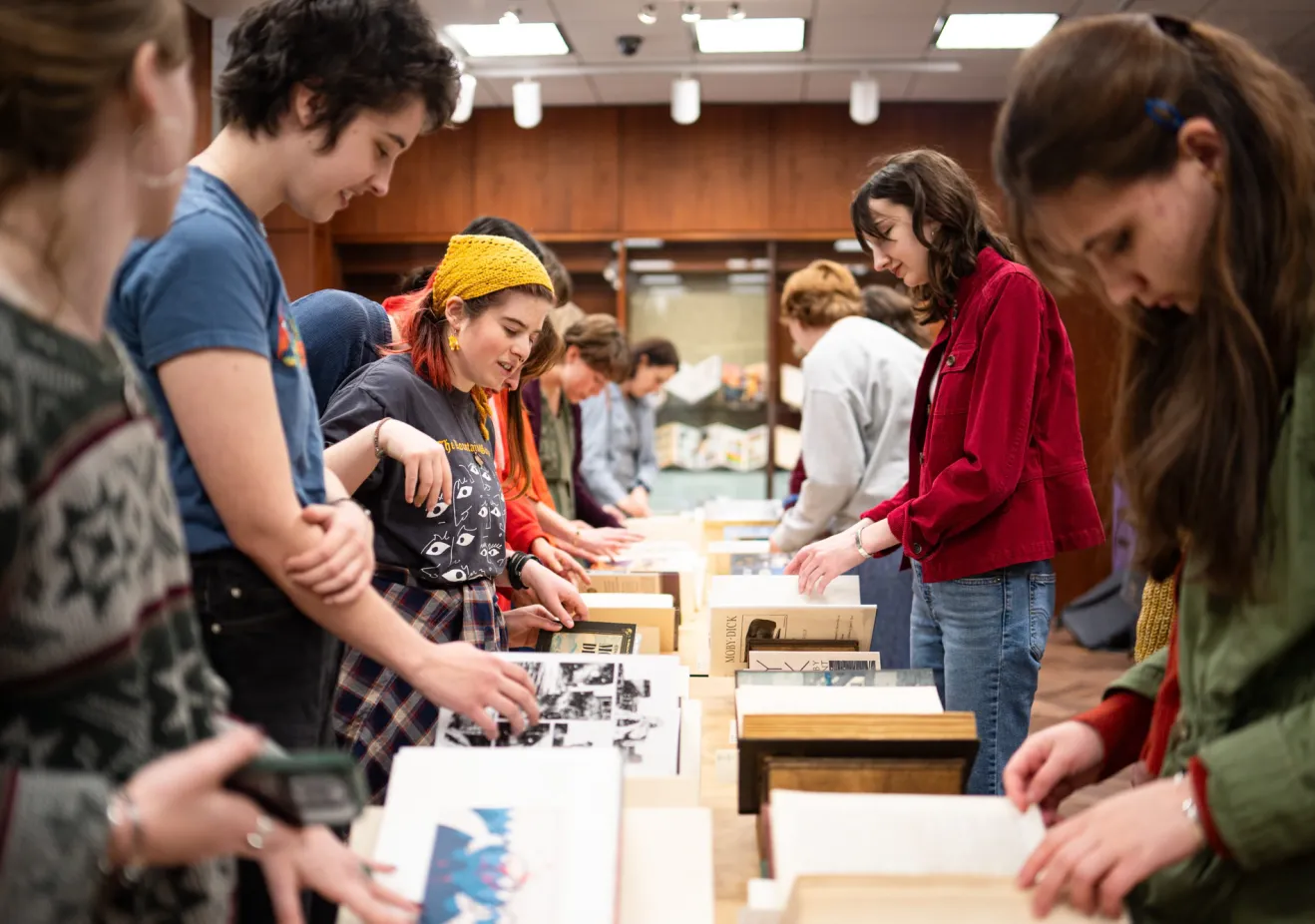 A group of students examine special collections books
