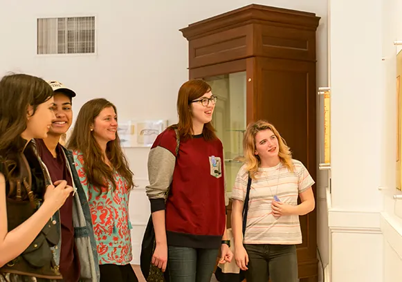 History of art Ph.D. students observing an artwork during a museum session supported by Bryn Mawr’s art curatorial fellowships.