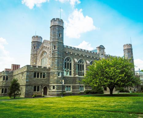 Large stone building with green grass