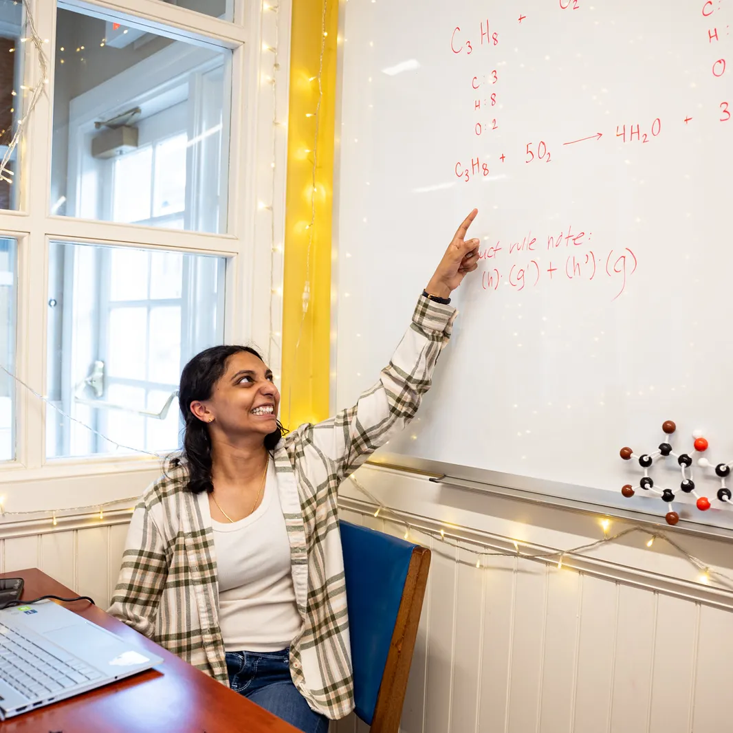 Student in Q Center at a whiteboard