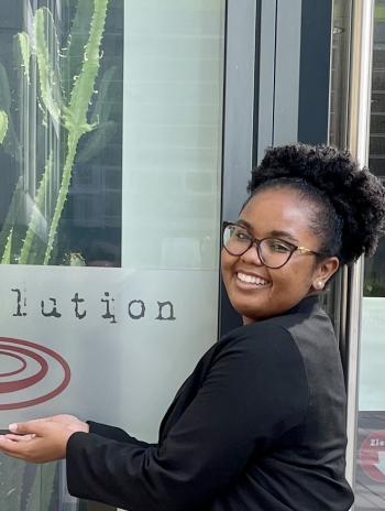 Whitney smiling next to a biolution sign