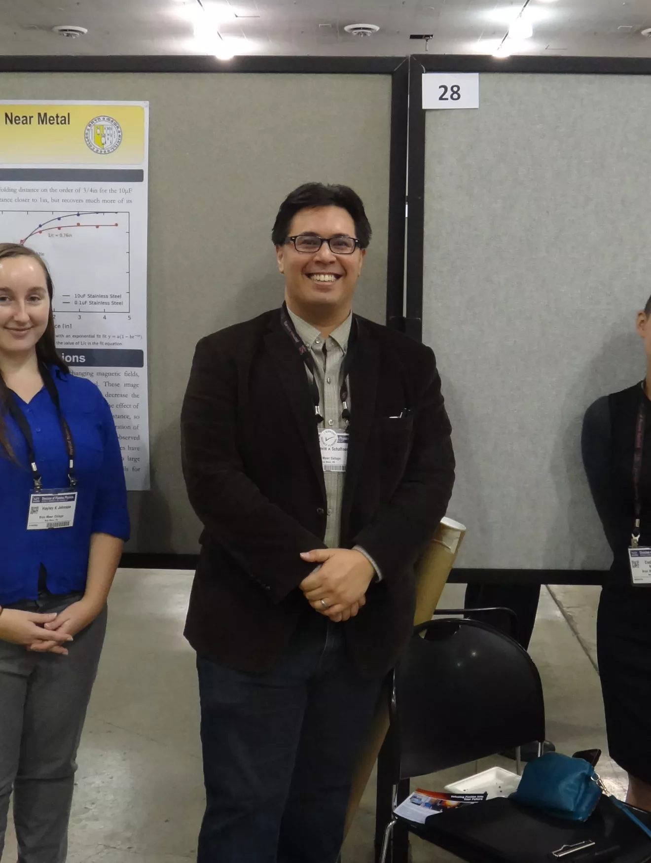 Codie Fiedler Kawaguchi and Hayley Johnson  in front of poster.