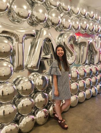 Kellie Stands in Front of BuzzFeed's Tasty Sign