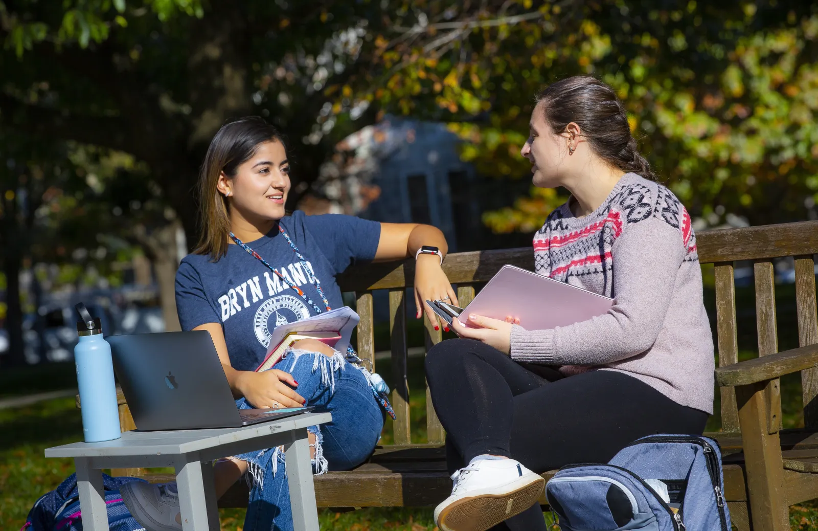 students sitting on bench talking