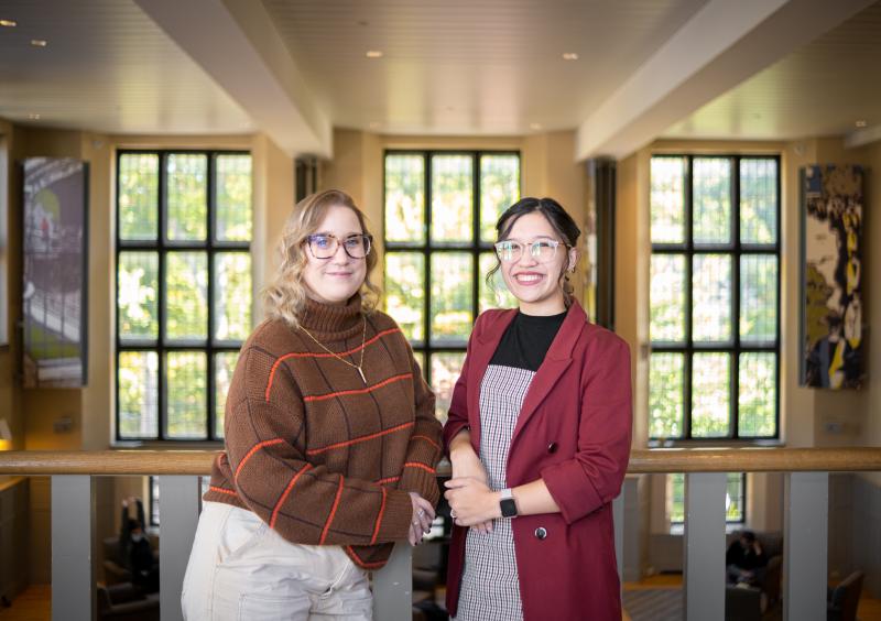 Left is Missy MacPherson and right is Mia Harvey posing in the Campus Center