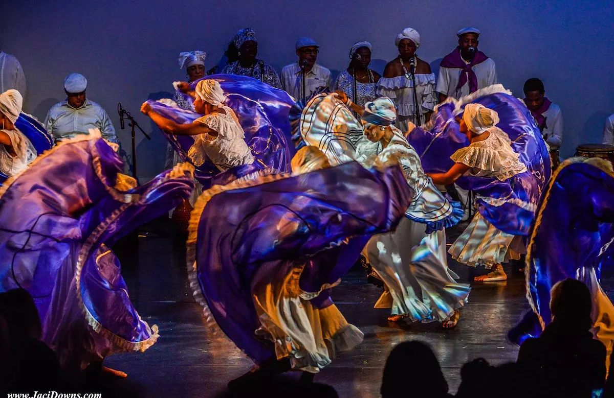 Dancers on stage in purple light