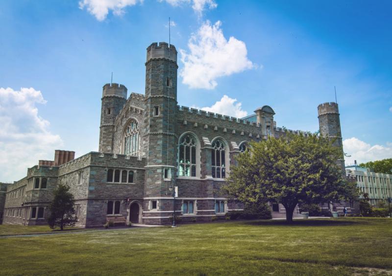 Large stone building with green grass