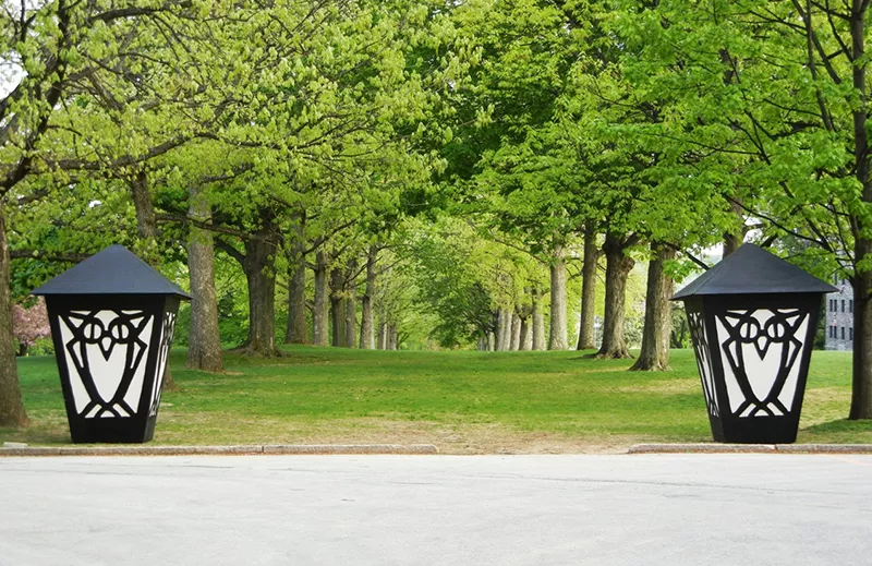Two large lanterns in front of a row of trees