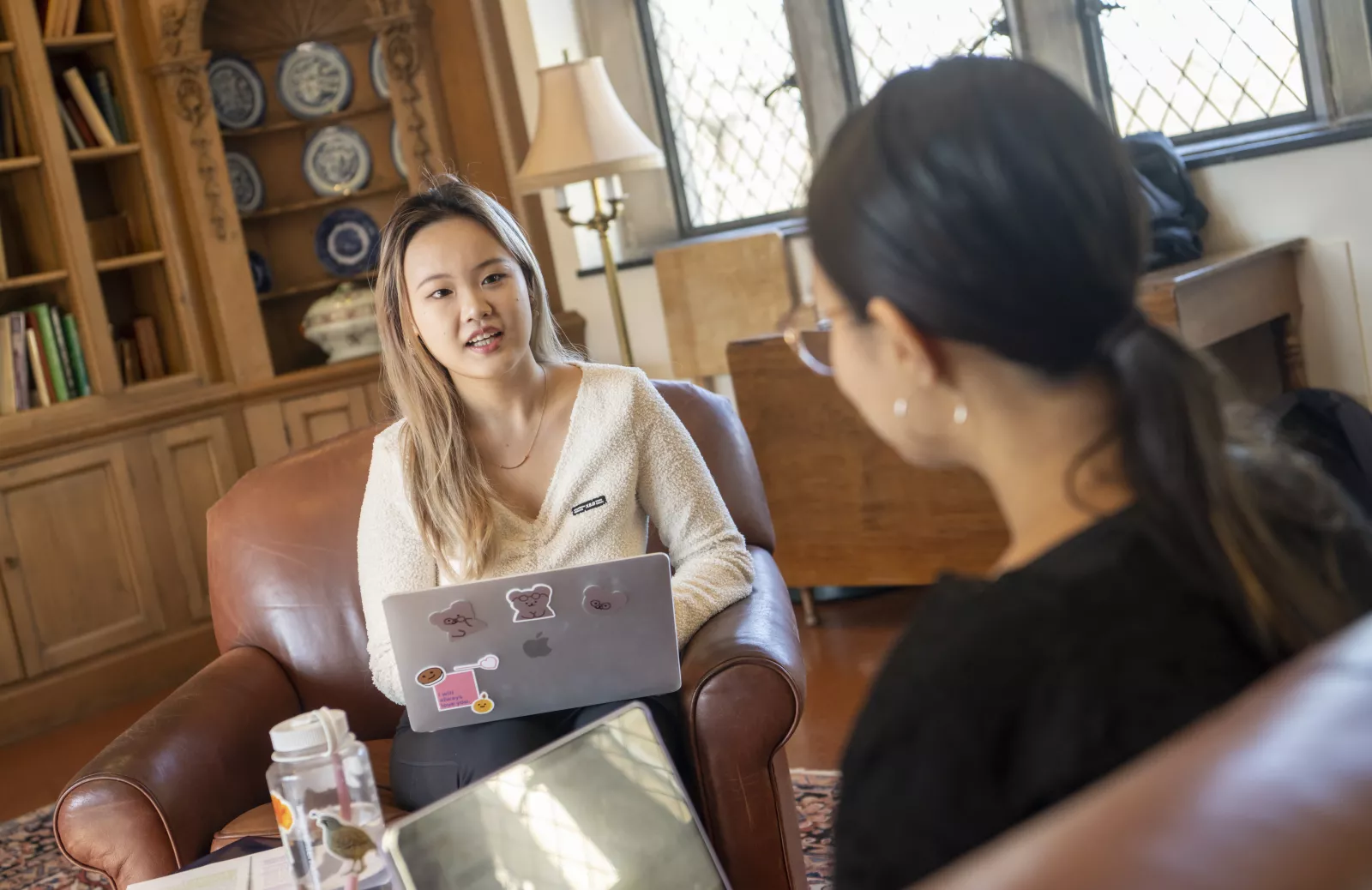 Two students talking to one another 