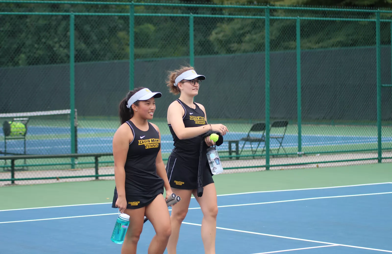 Wynn Bryant and Kelly Cole on a tennis court