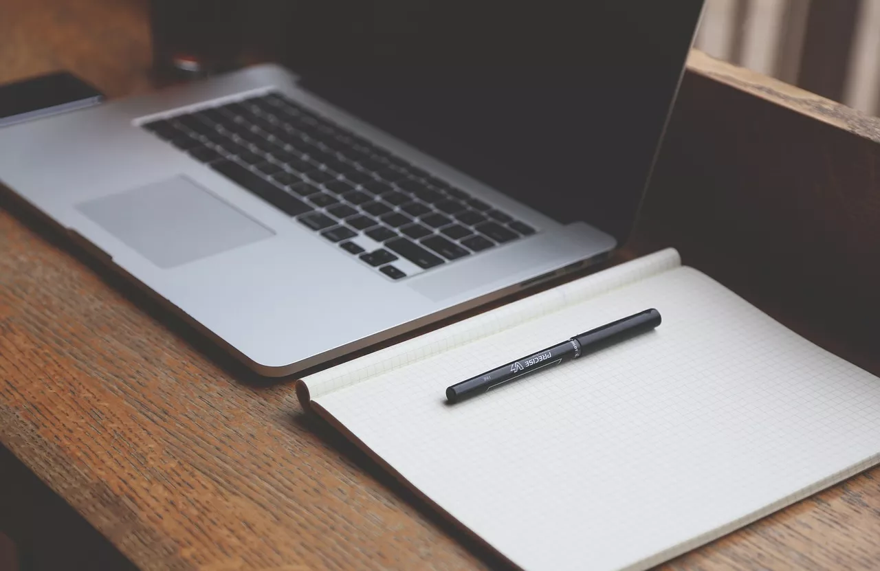 Laptop and Notebook on a Desk
