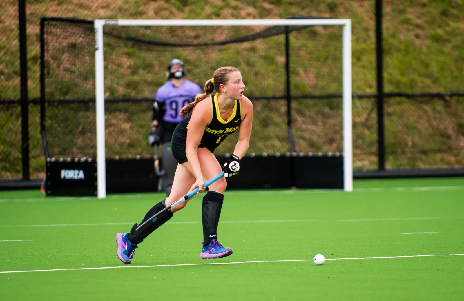 student playing field hockey