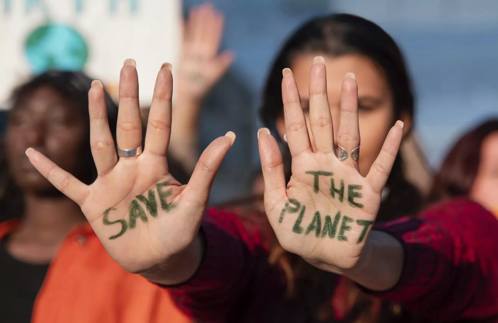 Protester with "Save the Planet" written on hands