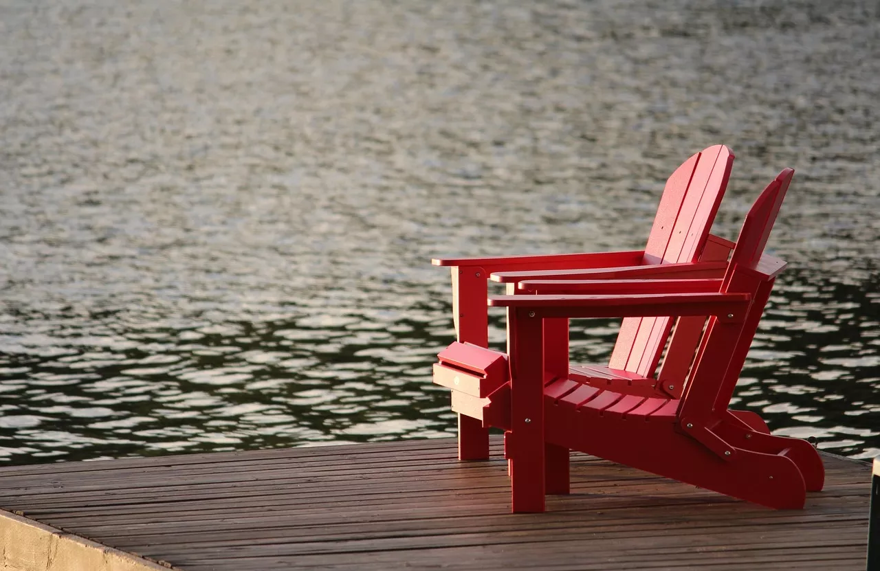 Adirondack chairs by the water
