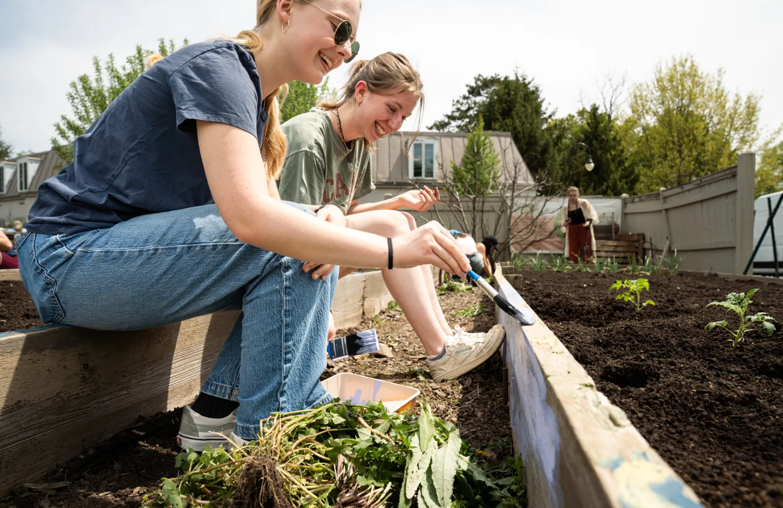 Clara Thomas ’26 and Sophie Sweeting ’26 work in the Community Garden. Photo by Caroline Bittenbender.