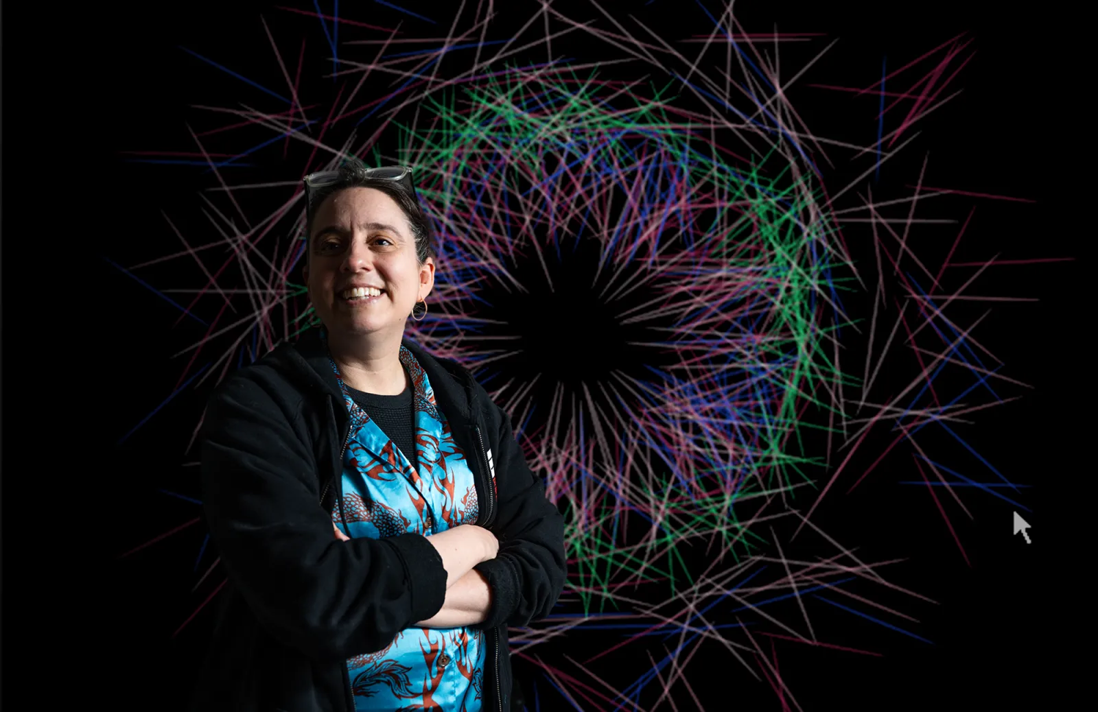 Aline standing in front of one of her designs