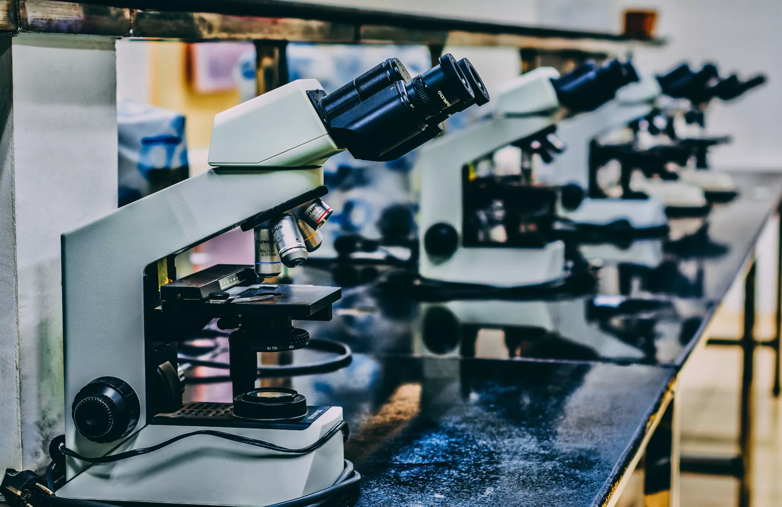 white microscope on top of black table photo