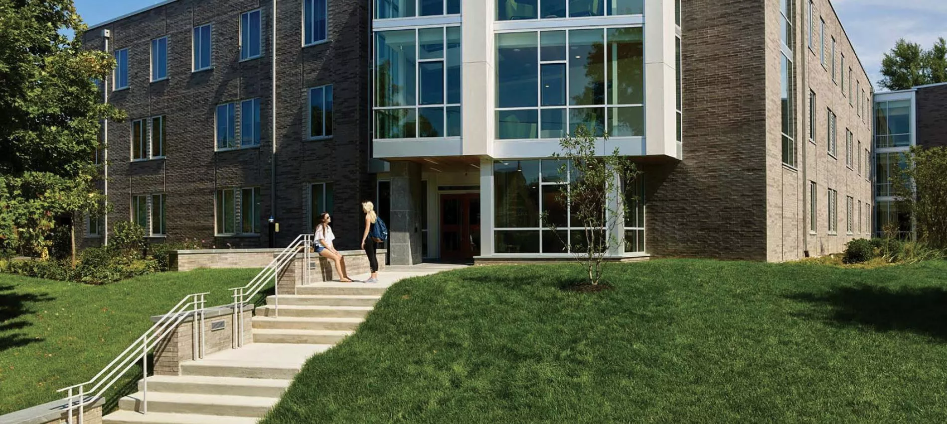 Students sitting outside of New Dorm