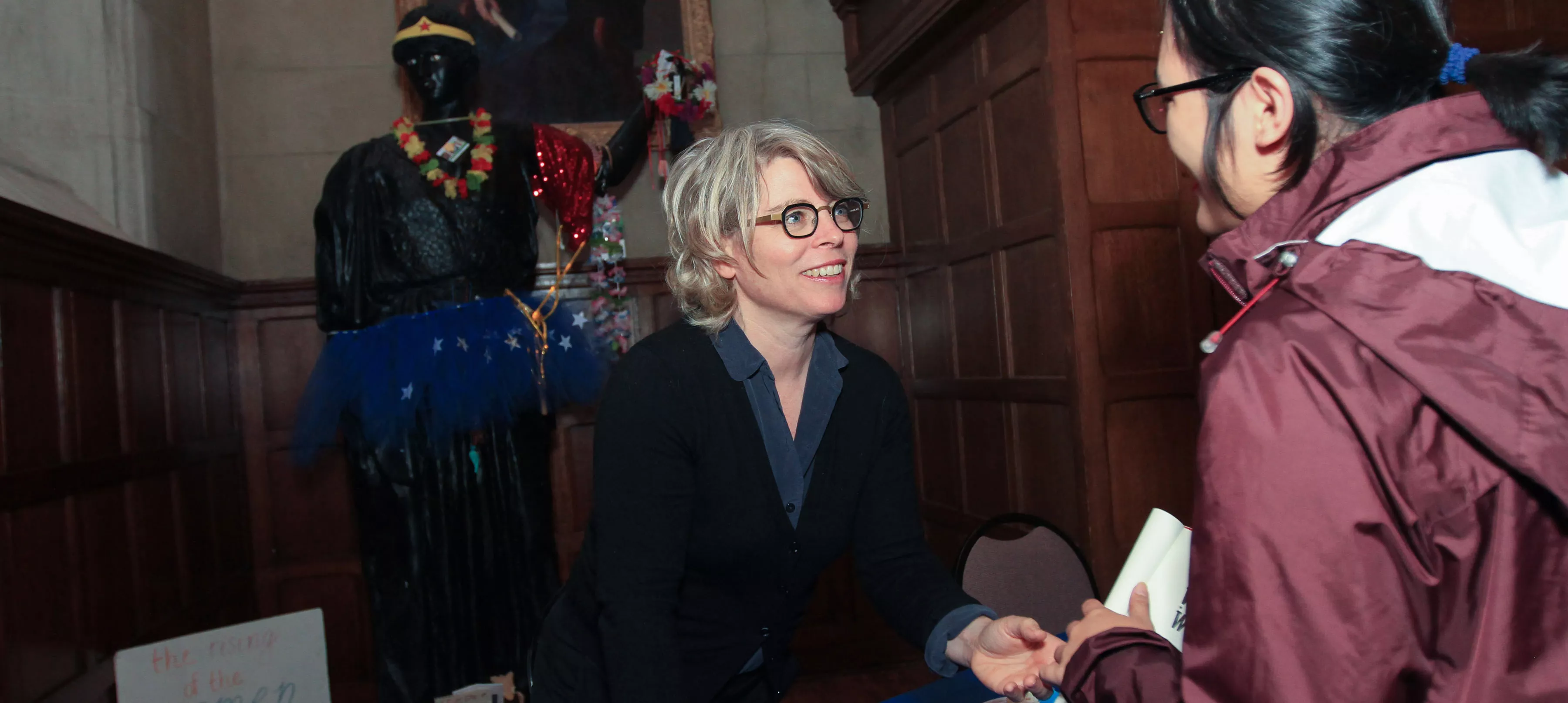 author shaking hands with student