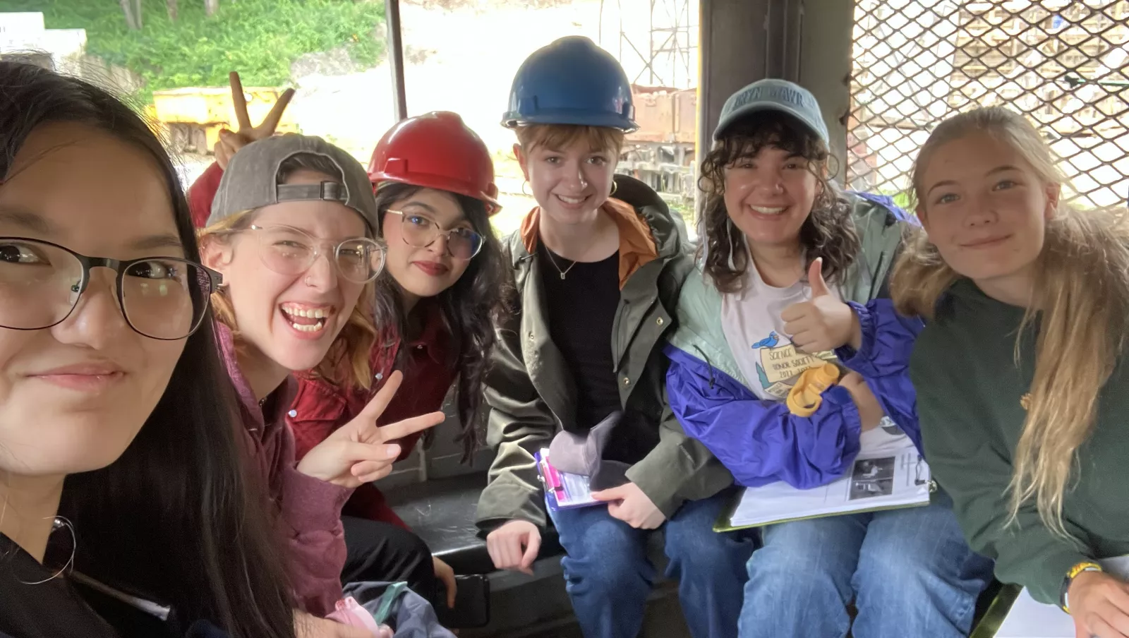 Fellows posing in train that takes them into the coal mine.