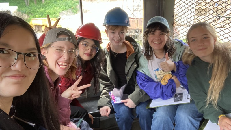 Fellows posing in train that takes them into the coal mine.