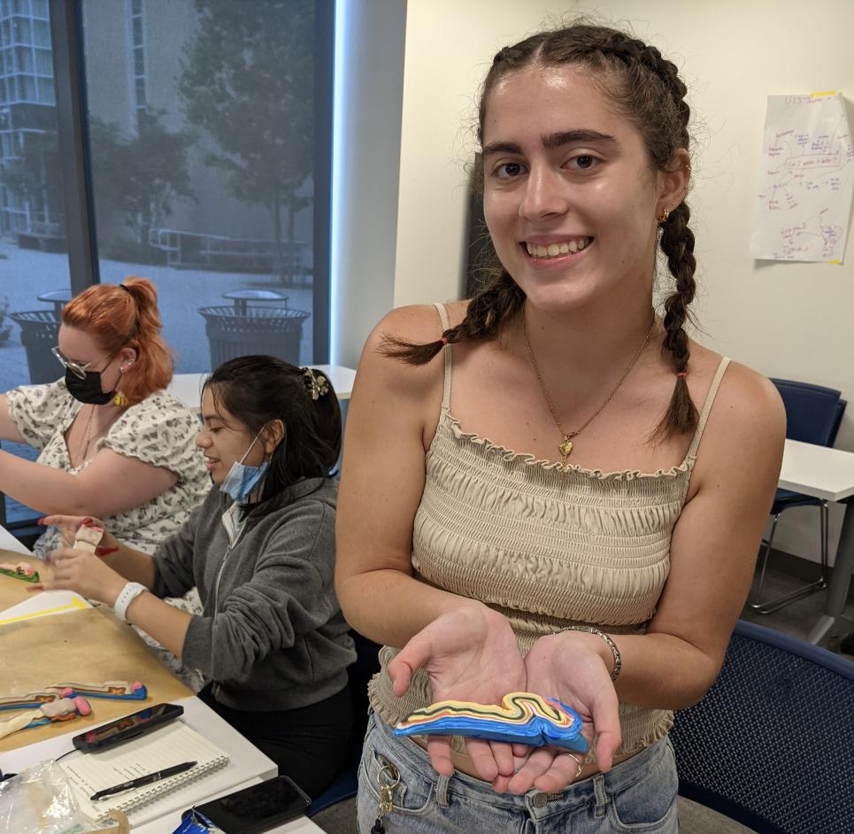 Ninel holds a clay figure that represents how the Appalachian mountains were formed