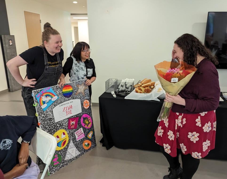 Prof. Ziva Myer receives a giant thank-you card from students