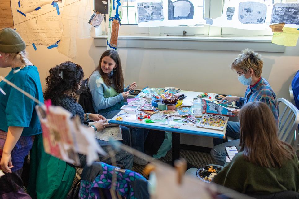 Students collaging together at tables