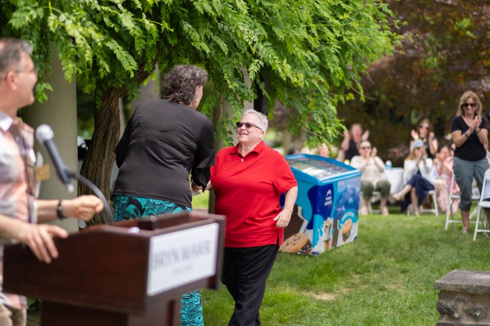 Angie Sheets shakes hands with Kim Cassidy at the Staff Picnic