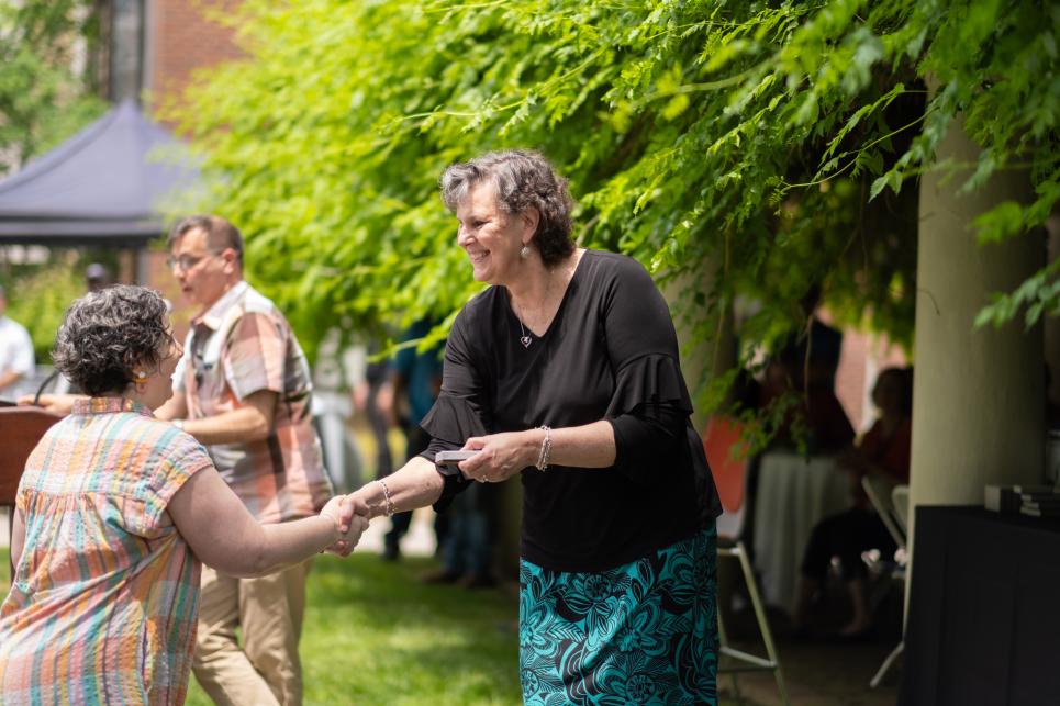 Amanda Chudnow shakes hands with Kim Cassidy at Staff Picnic