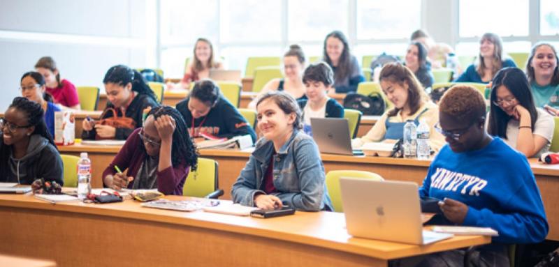 Students with laptops in a classroom learning