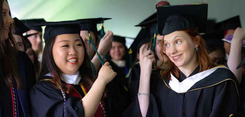 Two graduates at Commencement